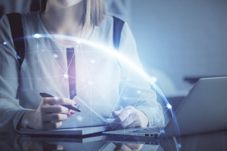 Double exposure of woman hands typing on computer and social network theme hologram drawing. People media concept.の写真素材