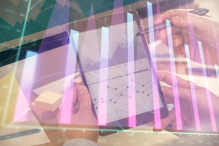 Double exposure of man's hands holding and using a phone and financial chart drawing. Market analysis concept.の写真素材