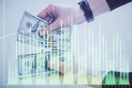 Multi exposure of financial graph drawing hologram and USA dollars bills and man hands. Analysis concept.の写真素材