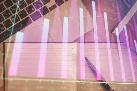Stock market chart and top view computer on the table background. Double exposure. Concept of...