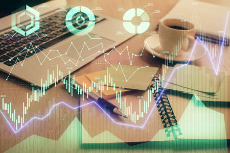 Multi exposure of forex graph drawing and desktop with coffee and items on table background. Concept...