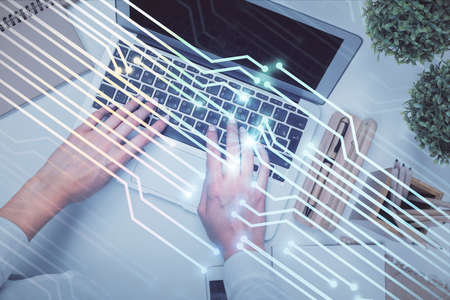 Double exposure of woman hands working on computer and data theme hologram drawing. Top View. Technology concept.の写真素材