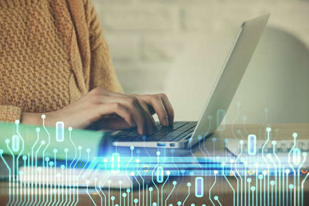Double exposure of woman hands working on computer and data theme hologram drawing. Tech concept.の写真素材