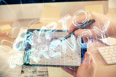 Double exposure of man's hands holding and using a phone and crypto currency blockchain theme drawing.の写真素材
