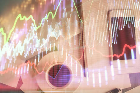 Multi exposure of forex graph hologram over desktop with phone. Top view. Mobile trade platform concept.の写真素材