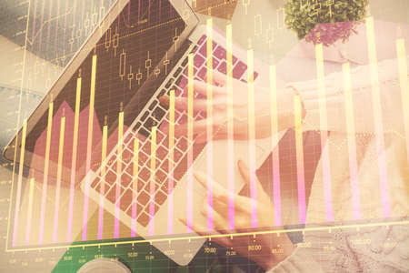 Double exposure of woman hands working on computer and forex chart hologram drawing. Top View....