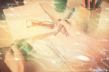 Double exposure of woman on-line shopping holding a credit card and data theme hologram drawing. E-commerce concept.の写真素材