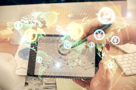 Double exposure of man's hands holding and using a phone and financial chart drawing. Market...