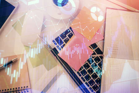 Multi exposure of financial chart drawing over table background with computer. Concept of research and analysis. Top view.の写真素材