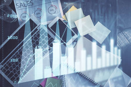 Financial market graph and top view computer on the desktop background. Multi exposure. Investment...
