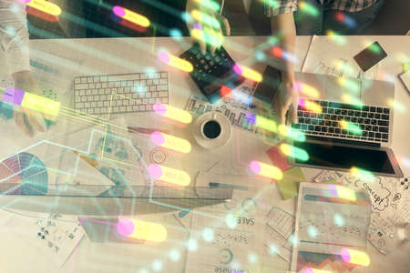 Double exposure of man and woman working together and technology theme drawing hologram. Big data...