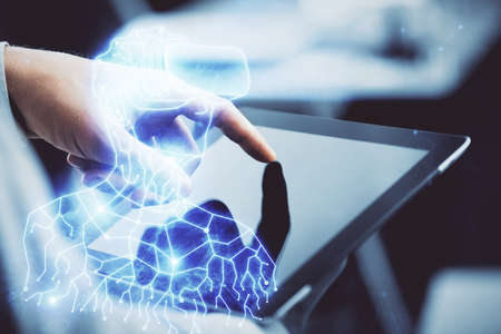 Double exposure of man's hands holding and using a digital device and AR glasses drawing. Virtual...