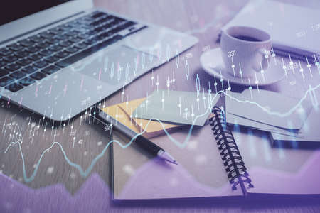 Multi exposure of forex graph drawing and desktop with coffee and items on table background. Concept...