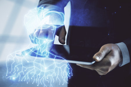 Double exposure of man's hands holding and using a digital device and AR glasses drawing. Virtual...