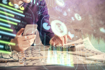Multi exposure of man's hand holding and using a digital device and data theme drawing. Innovation concept.の写真素材