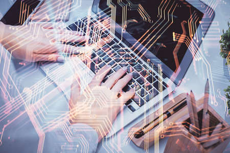 Double exposure of woman hands typing on computer and technology theme drawing. High Tech concept.の写真素材