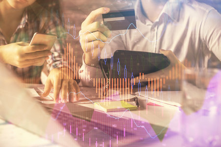 Double exposure of man and woman on-line shopping holding a credit card and forex graph hologram...