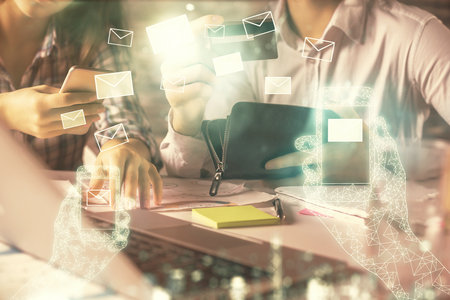 Double exposure of man and woman on-line shopping holding a credit card and envelop fly hologram...