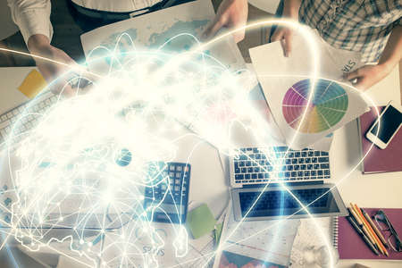 Double exposure of man and woman working together and business theme hologram drawing. Computer background. Top View.の写真素材