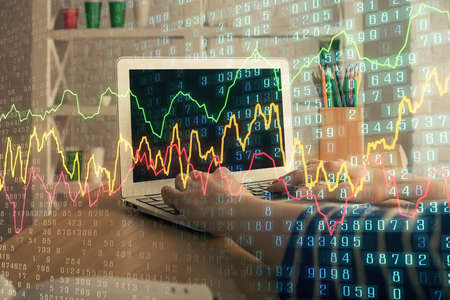 Double exposure of woman hands typing on computer and forex chart hologram drawing. Stock market invest concept.の写真素材