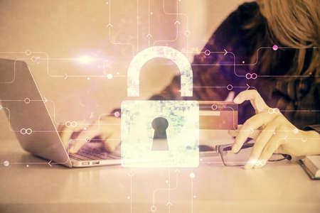 Double exposure of woman on-line shopping holding a credit card and Lock hologram drawing. Security...