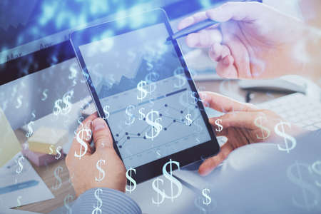 Double exposure of man's hands holding and using a phone and financial chart drawing. Market analysis concept.の写真素材