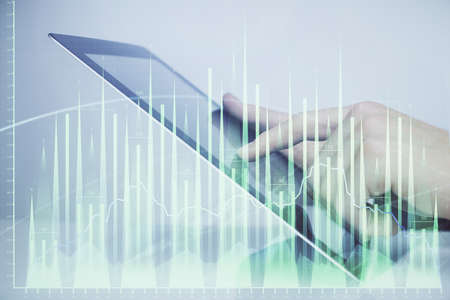 Multi exposure of man's hands holding and using a digital phone and forex graph drawing. Financial...