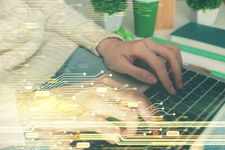 Double exposure of woman hands working on computer and data theme hologram drawing. Tech concept.