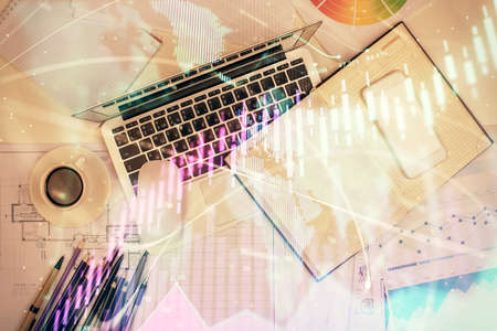 Multi exposure of forex chart drawing over table background with computer. Concept of financial...