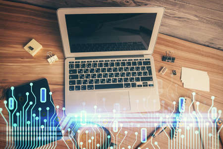 Double exposure of data hologram sketch over study table background with computer. Concept of Ai....