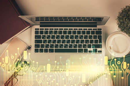 Double exposure of data theme drawing hologram over topview work table background with computer....