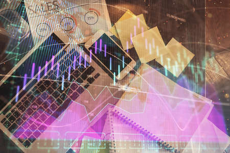 Financial market graph and top view computer on the desktop background. Multi exposure. Investment...