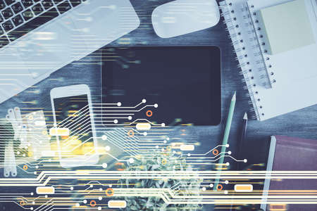 Double exposure of technology theme drawing over work table desktop. Top view. Global data analysis...