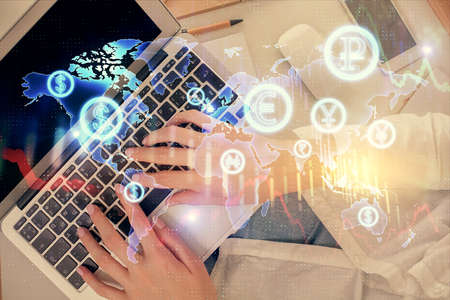 Double exposure of woman hands working on computer and forex chart hologram drawing. Top View....