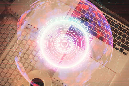 Technology hologram drawing over computer on the desktop background. Top view. Double exposure. Tech...