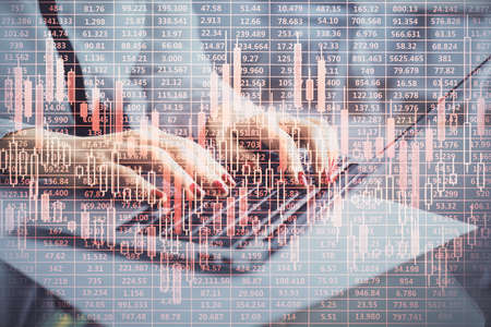 Multi exposure of woman hands typing on computer and financial graph hologram drawing. Stock market...