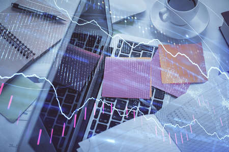 Multi exposure of financial chart drawing over table background with computer. Concept of research and analysis. Top view.の写真素材