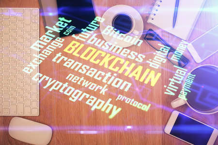 Double exposure of blockchain theme hologram over table with phone. Top view. Crypto technology concept.の写真素材