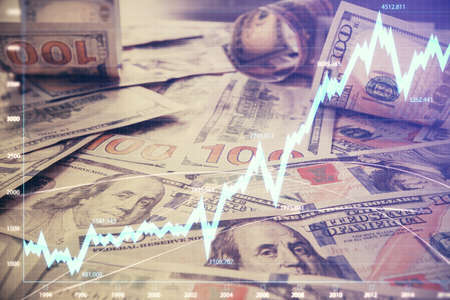 Multi exposure of forex chart drawing over us dollars bill background. Concept of financial success markets.の写真素材