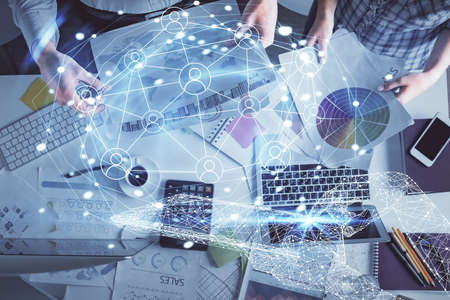 Double exposure of man and woman working together and social network theme hologram drawing....