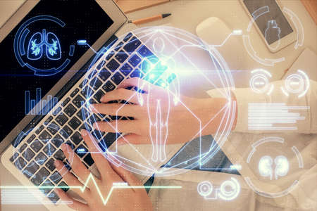 Double exposure of woman hands working on computer and education theme hologram drawing. Top View....