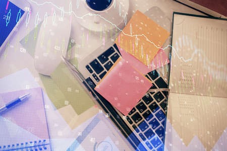 Multi exposure of financial chart drawing over table background with computer. Concept of research and analysis. Top view.の写真素材