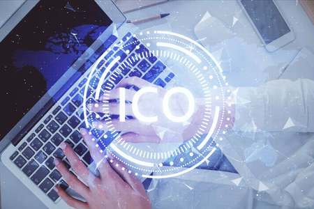 Double exposure of woman hands working on computer and blockchain theme hologram drawing. Top View. bitcoin cryptocurrency concept.の写真素材