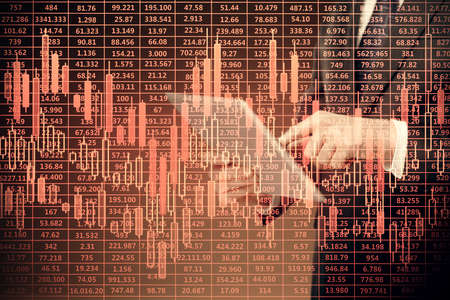Double exposure of man's hands holding and using a digital device and forex graph drawing. Financial...