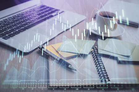 Multi exposure of forex graph drawing and desktop with coffee and items on table background. Concept...