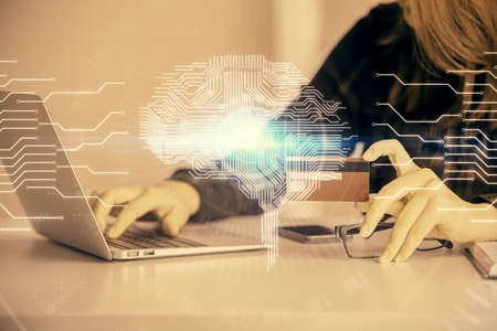 Double exposure of woman on-line shopping holding a credit card and brain hologram drawing. Data...