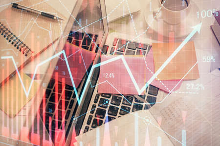Multi exposure of financial chart drawing over table background with computer. Concept of research and analysis. Top view.の写真素材