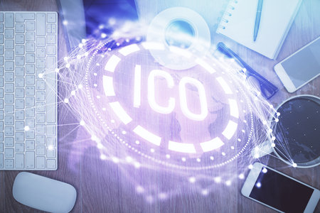 Double exposure of blockchain theme hologram over table with phone. Top view. Crypto technology concept.の写真素材