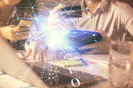 Double exposure of man and woman on-line shopping holding a credit card and data theme hologram...