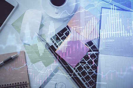 Multi exposure of financial chart drawing over table background with computer. Concept of research and analysis. Top view.の写真素材